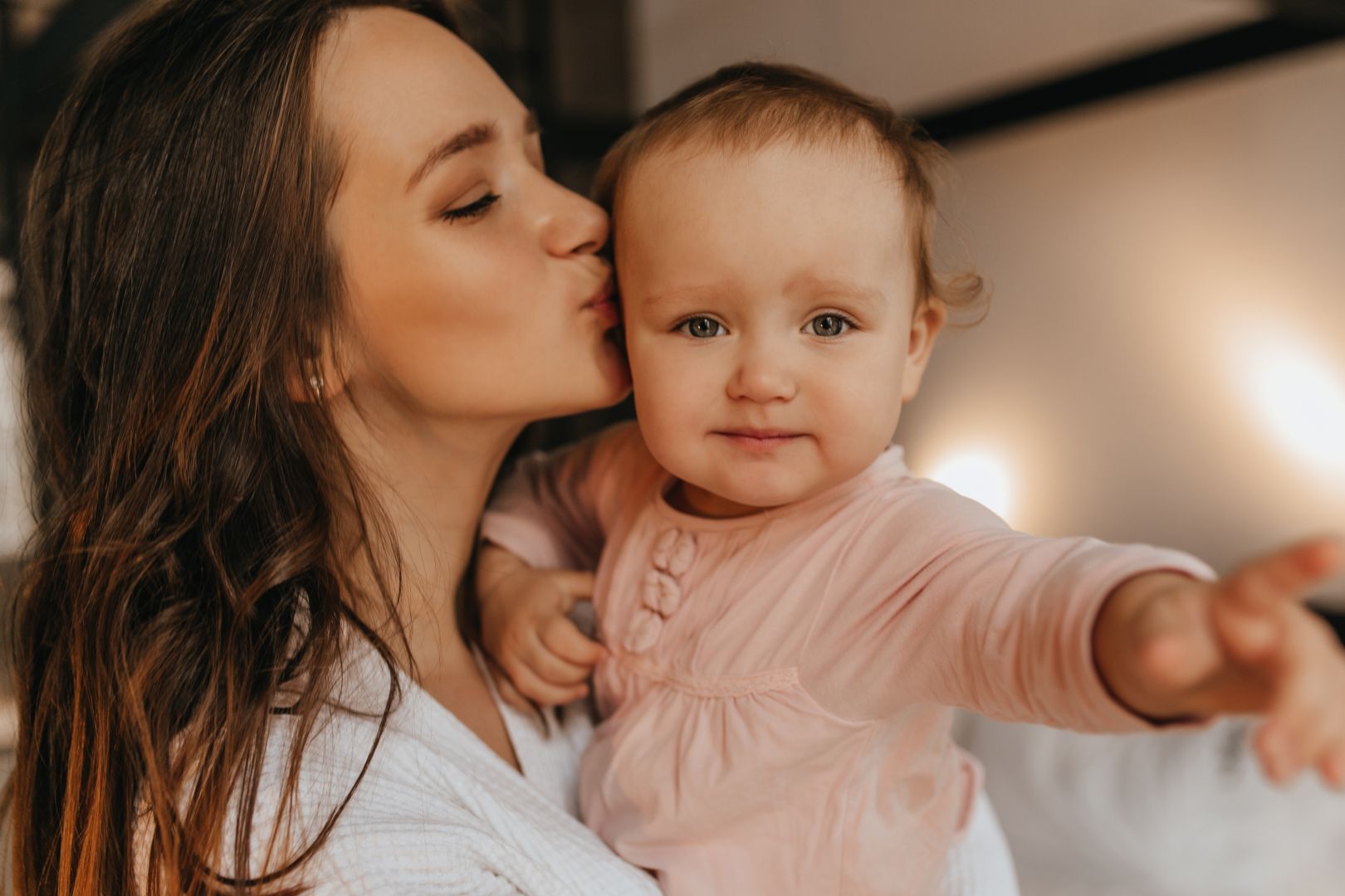 portrait-woman-white-home-clothes-her-blue-eyed-baby-lady-lovingly-kisses-her-daughter.jpg